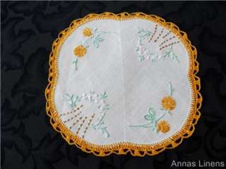 pretty vintage doily with hand embroidered flowers on a fine white 