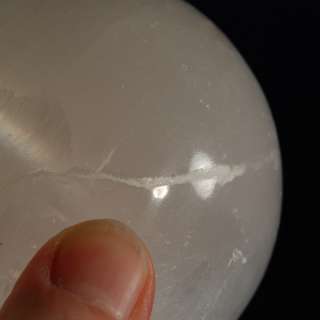 You are considering a White Selenite crystal sphere with a hematite 
