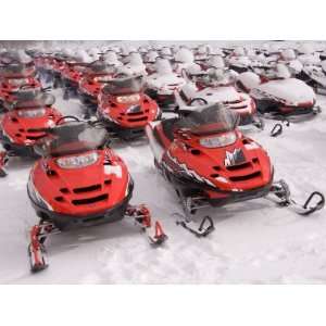  A Row of Snowmobiles Sit Waiting for the Next Adventure to 